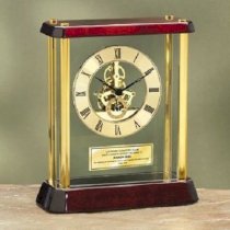 Premier Personalized Table Glossy Cherry Wood Desk Clock Enclosed in Glass Box and Brass Pillars with Da Vinci Dial and Gold Engraving Plate. This personalized clock is a nice anniversary gift, retirement gift and corporate employee recognition service aw